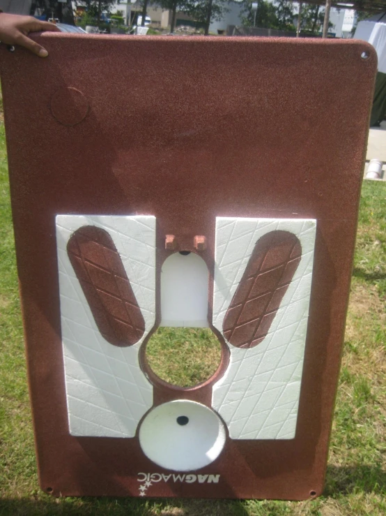 a toilet is shown in a park like setting