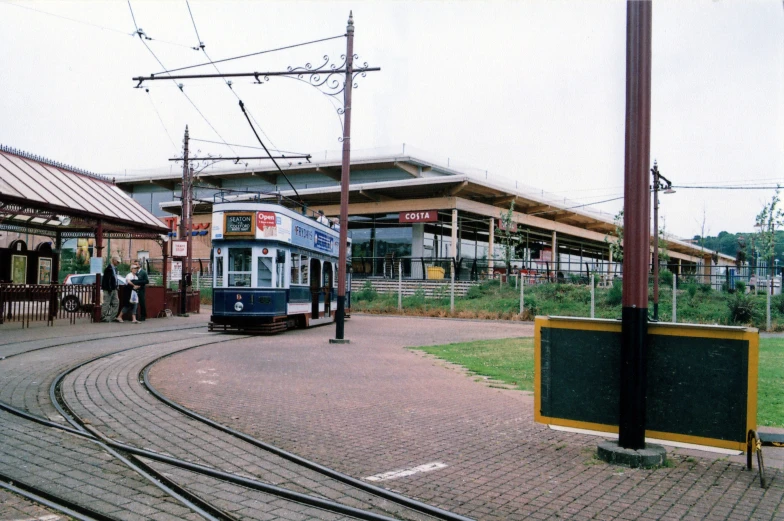 a double decker train sits at the end of a rail road track