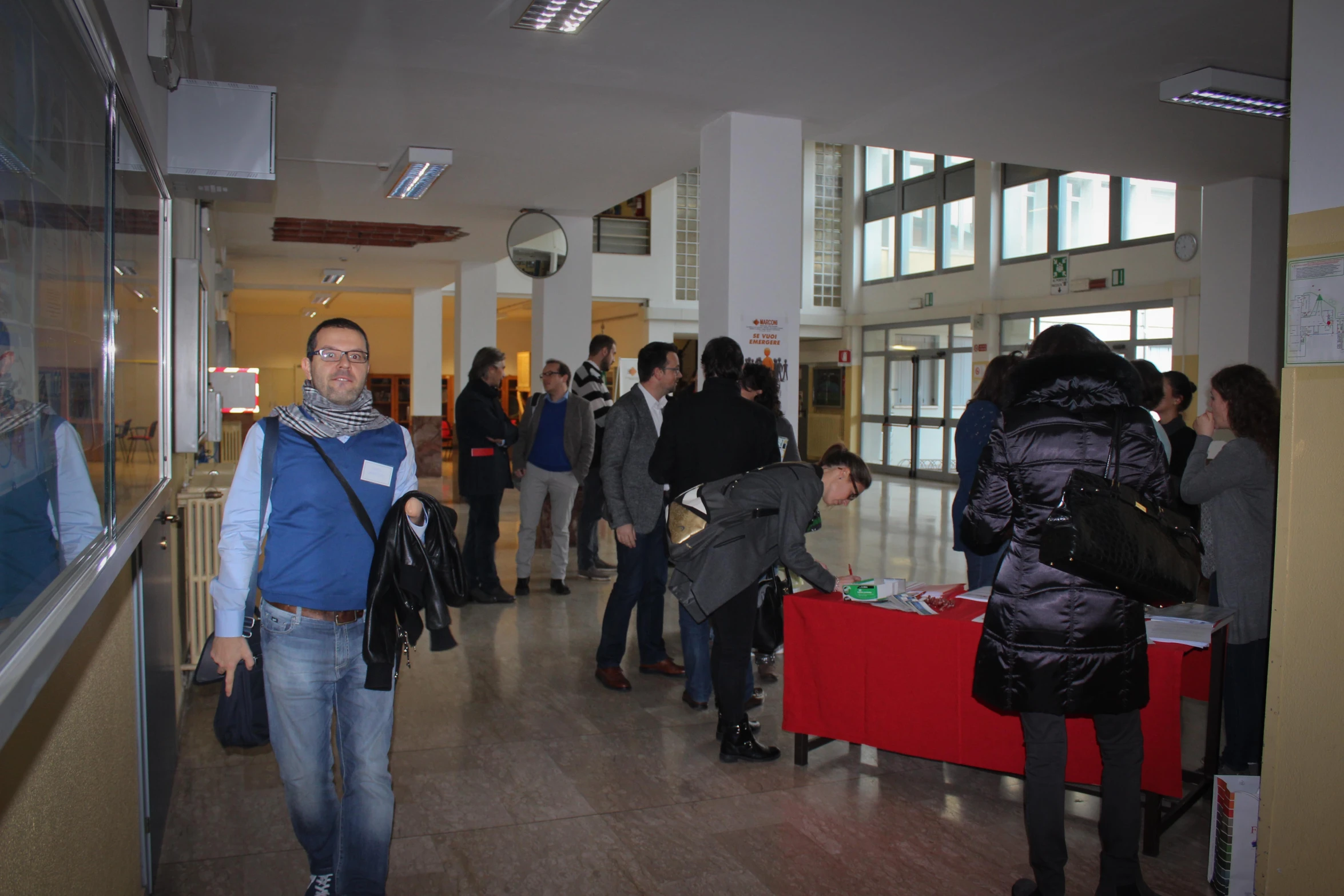 people standing in a line looking through glass