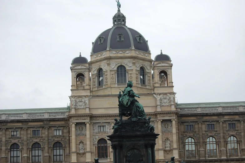 a statue sits near the entrance to a building