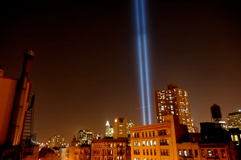 two jets fly over the city at night