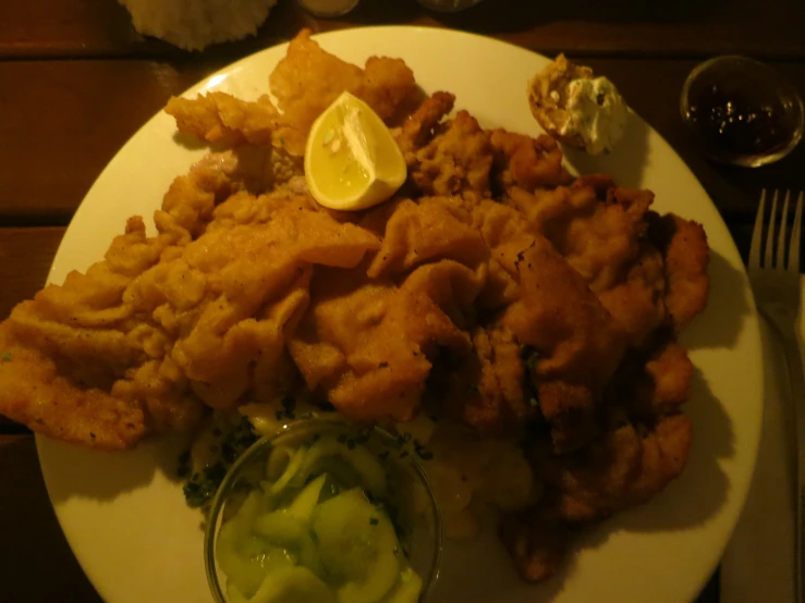 a white plate filled with fried food and some gravy