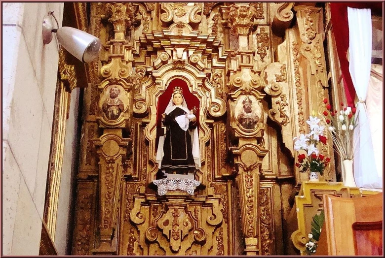 an ornate wooden shrine on the side of a church