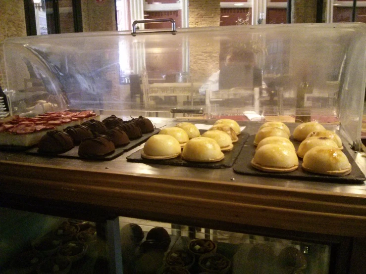 assorted desserts displayed in case with window