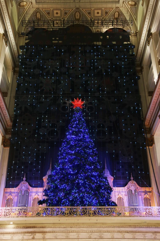 a large decorated christmas tree and stairs