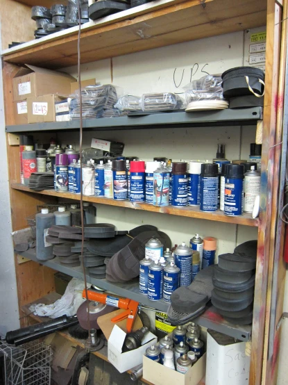 an old and messy work area with many shelves full of materials