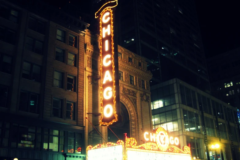 a lighted chicago sign is glowing at night