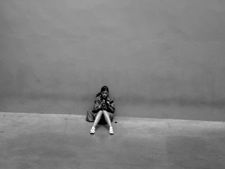 a woman sits on the floor with a backpack