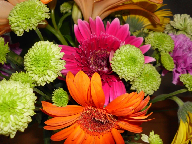 a large bouquet of colorful flowers displayed on a table