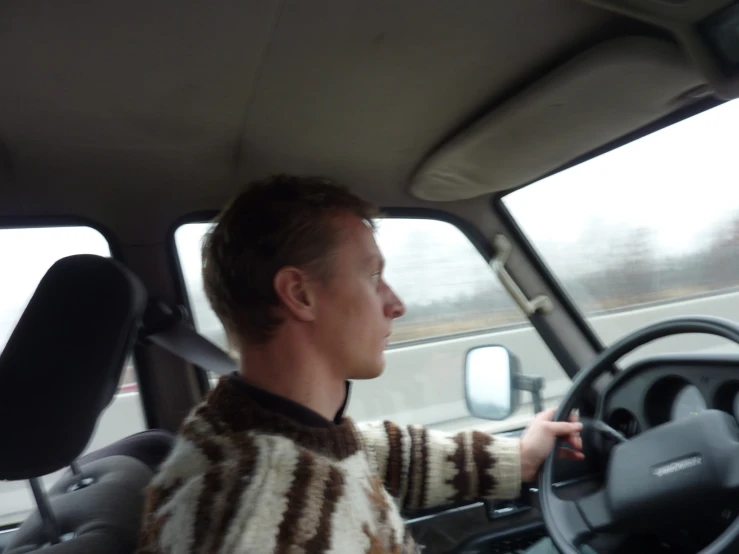 a man driving on his own side driving a car