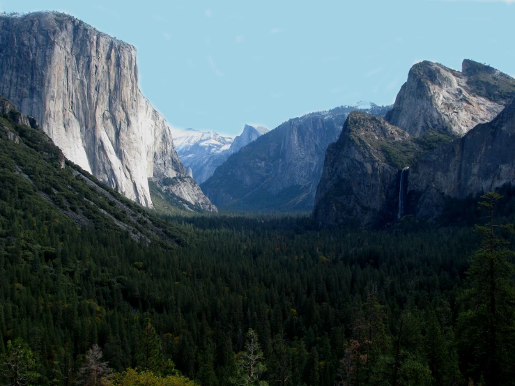 mountains with snow capped tops rise above a valley