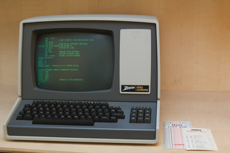 an old computer with a keyboard and mouse on top of a desk