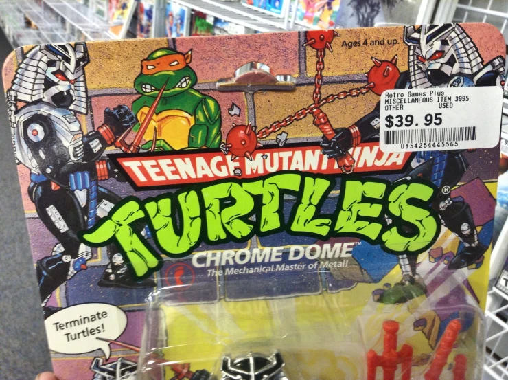 someone holds up a package of teenage mutant ninja toys