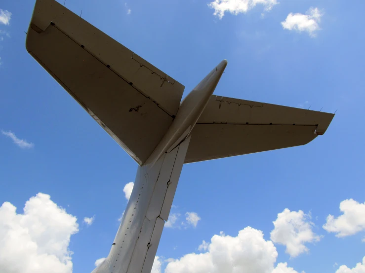 the side of an airplane's wing against a blue sky