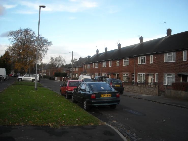 several cars are parked at the end of this street