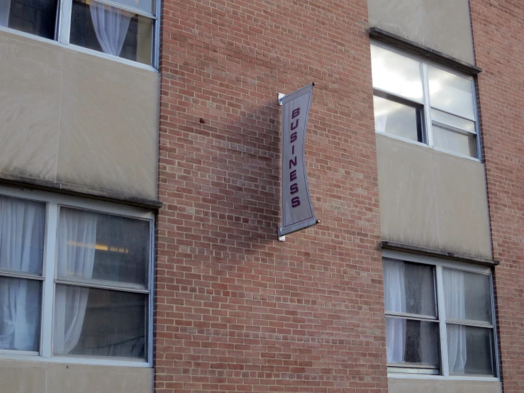 the front side of an apartment building, showing a sign in the window