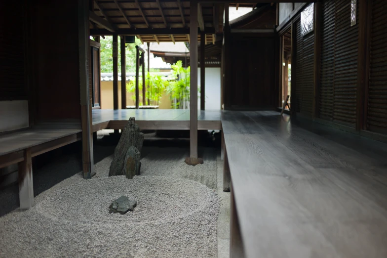 an indoor courtyard has a stone planter by it