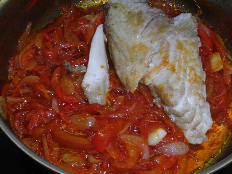cooked fish with sauce cooking in a large bowl