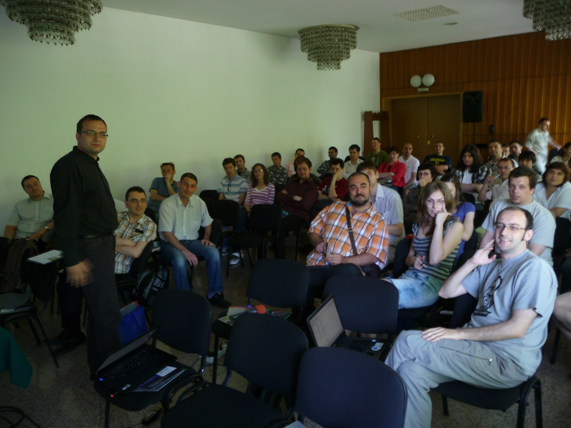 large group of people sitting in a room