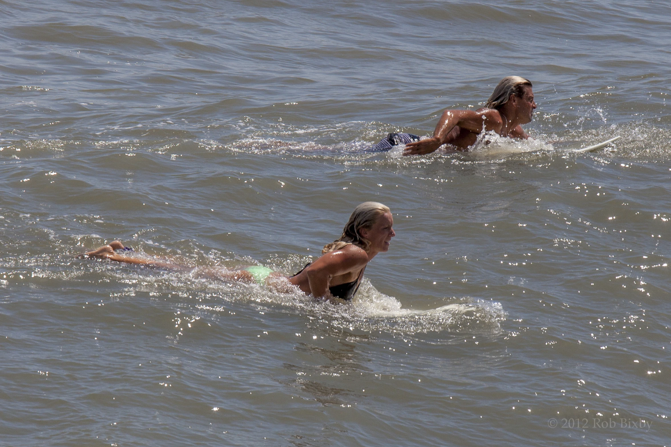 two females are swimming in the water together