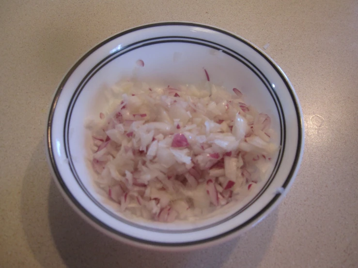 a bowl of food with onions and other things
