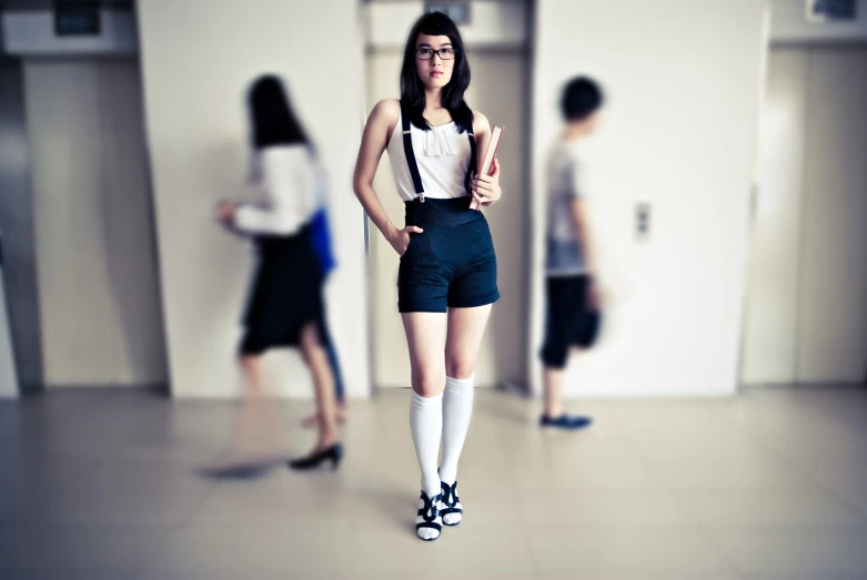 a woman in school shorts and socks standing