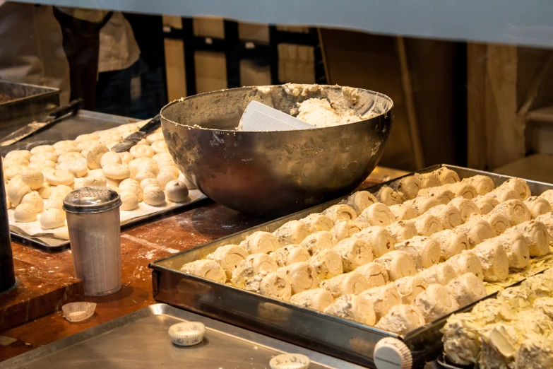 pans full of biscuits sitting on top of a stove