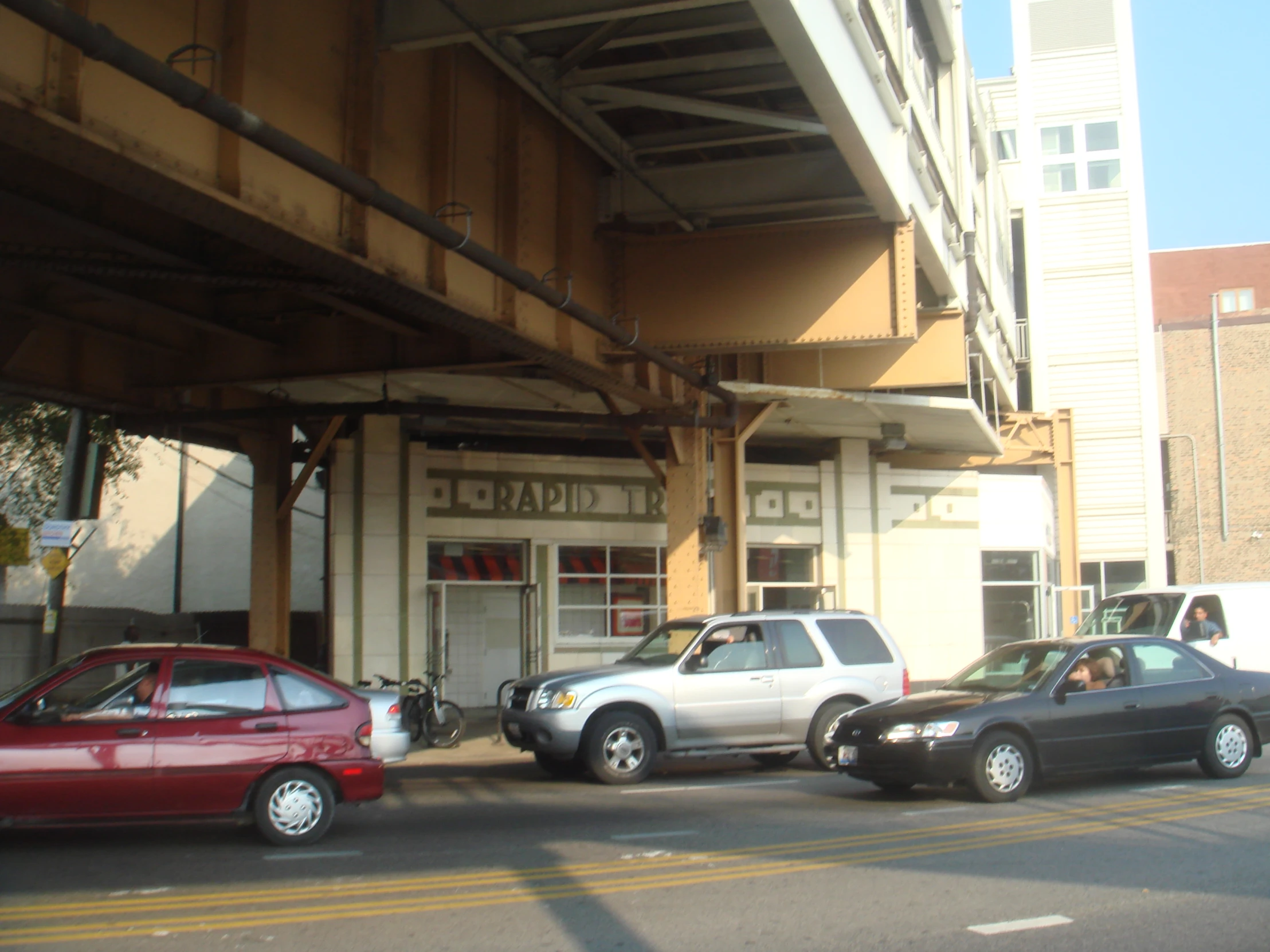 a street scene with focus on the cars parked on the sidewalk