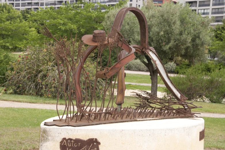 the sculpture has rusted leaves near it