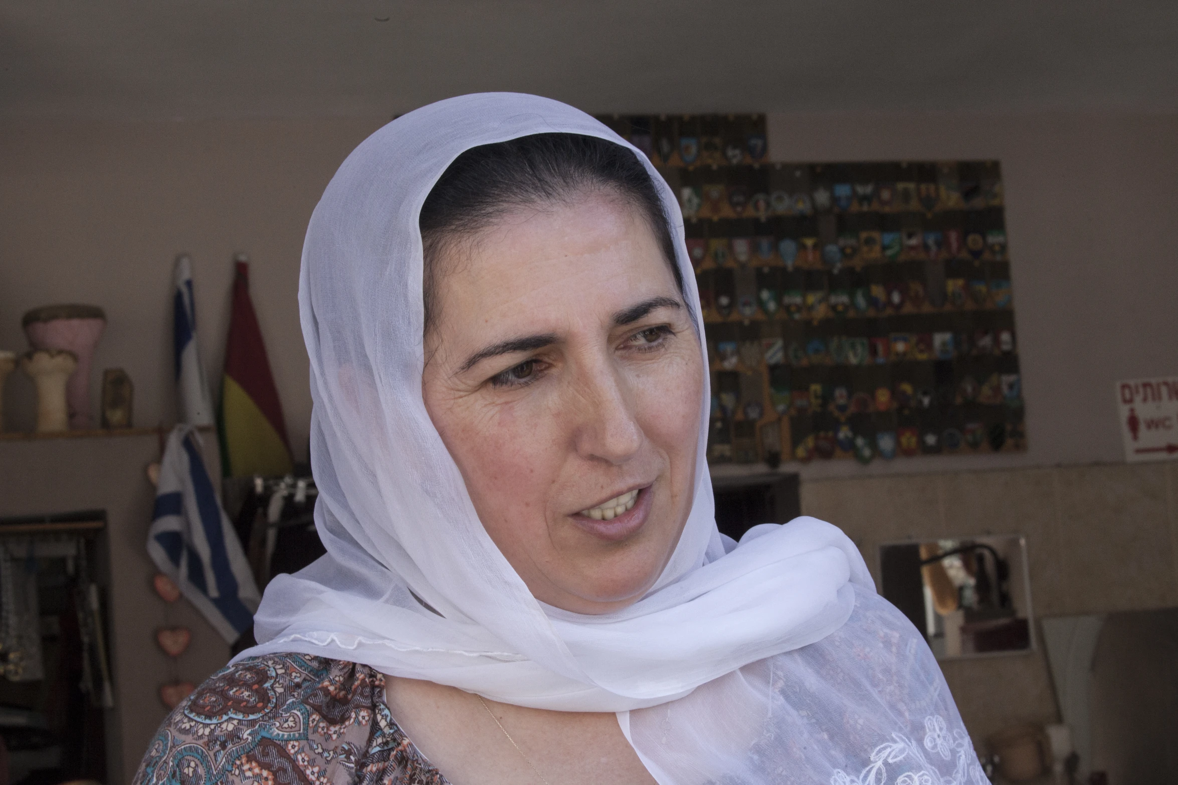 woman with white headscarf smiling in living room