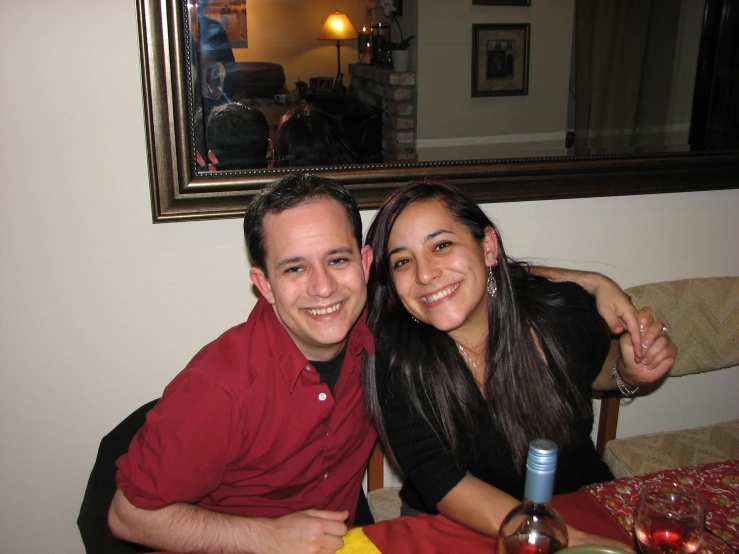 a woman and man sitting at a dinner table