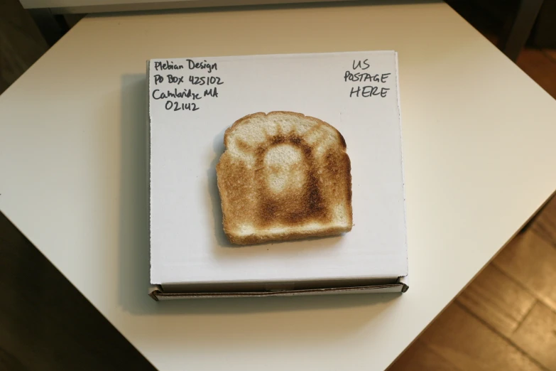 a piece of toast is sitting in a box on a table