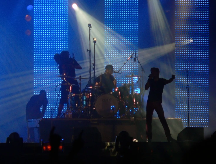 two men on stage with microphones and lights