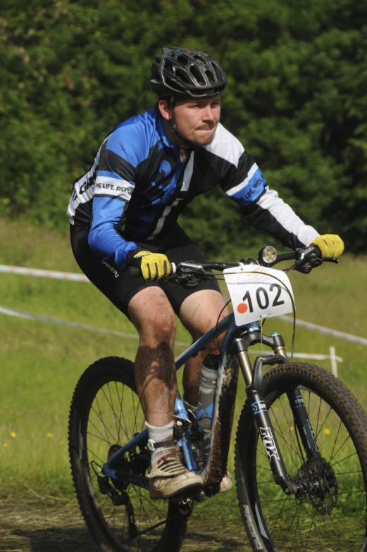 a man riding his bike on a dirt road