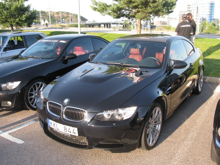 three black bmw cars parked on a parking lot