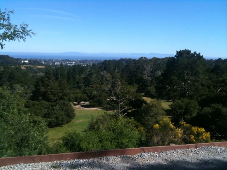 a view looking over a golf course from a hill top