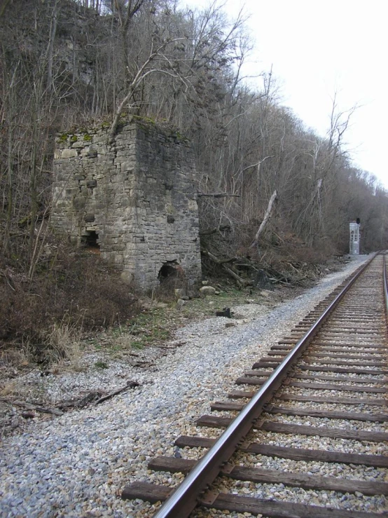 some tracks going in the same direction by an old brick building