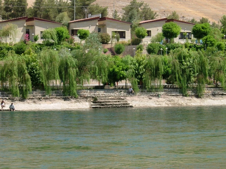 a group of buildings on the side of a river