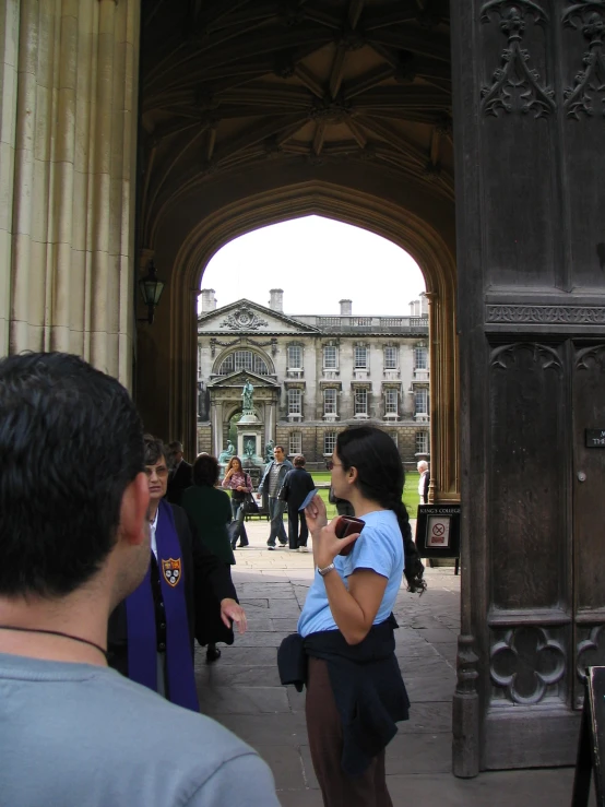 two people are seen walking under an arch in an ornate building