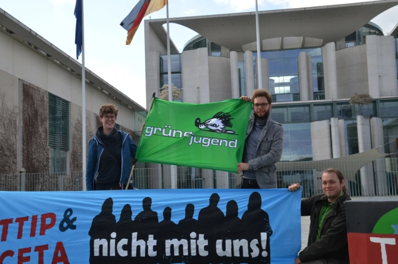 men holding signs and banners in front of buildings