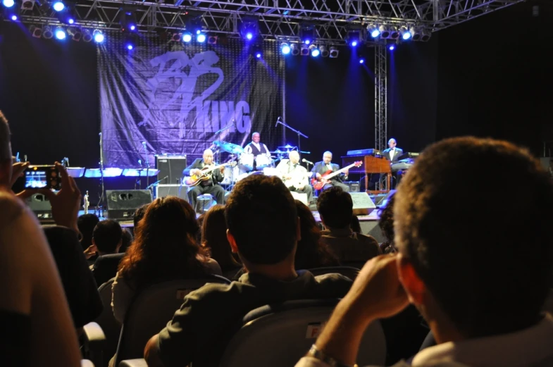 several people on a stage in front of a crowd