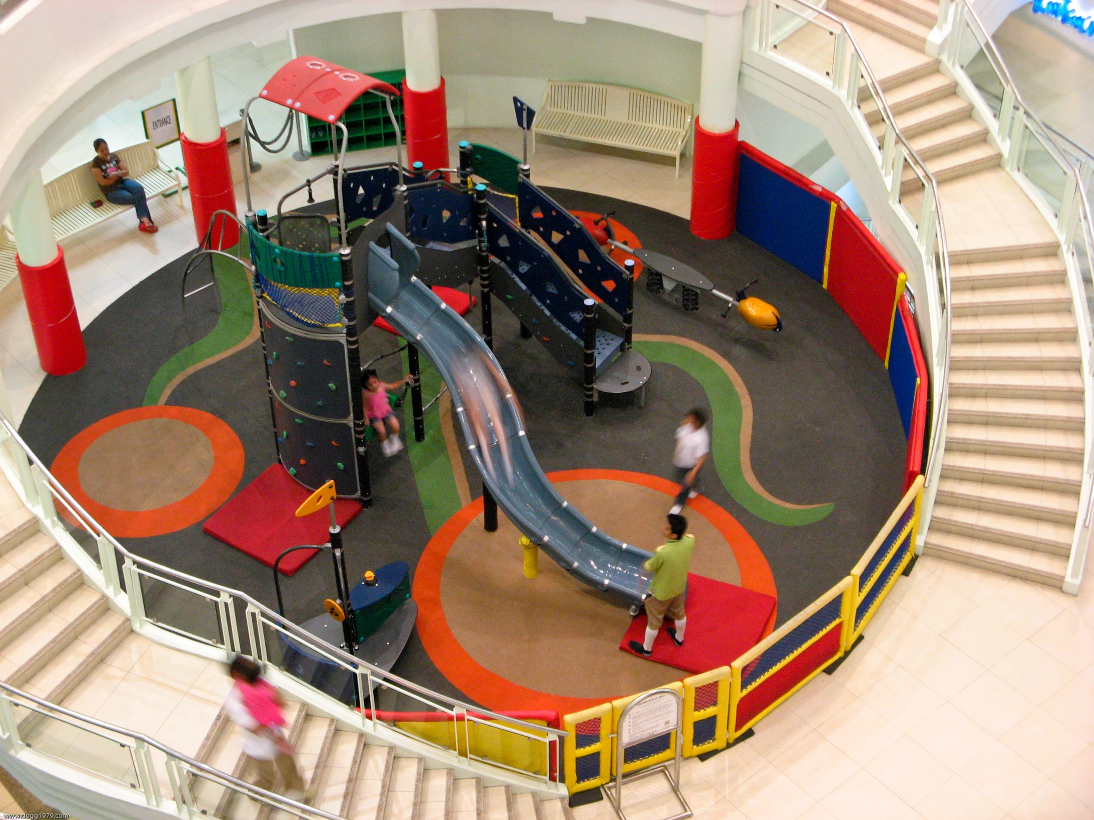 children playroom with slides and playground equipment in large building