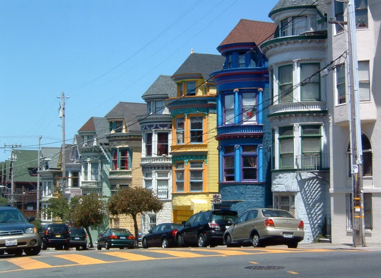 the houses in the middle of a street are painted in many different colors