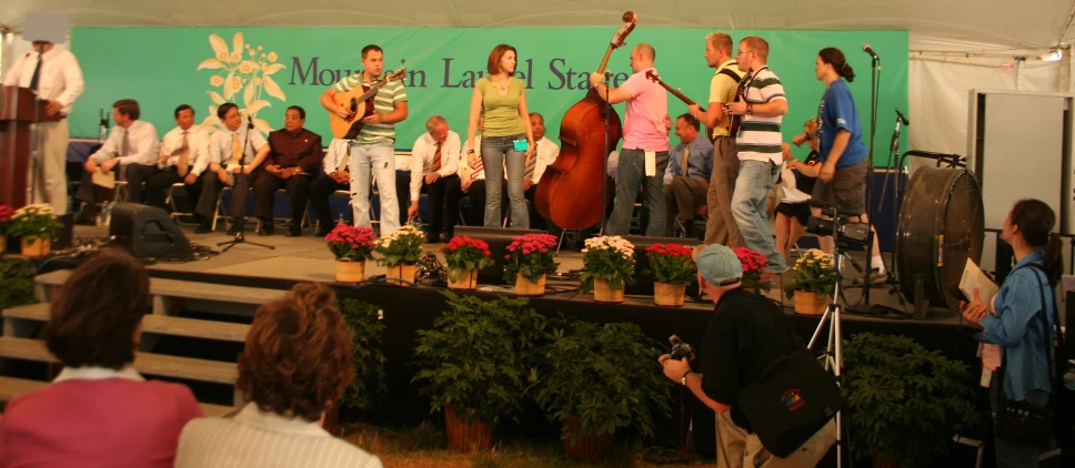 a band performs music on a stage while a crowd watches