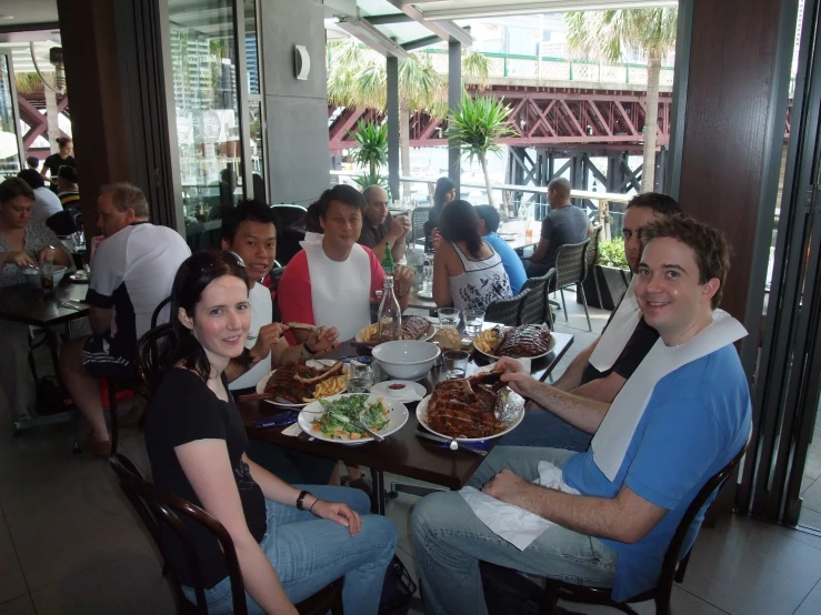 a group of people are sitting down and eating food