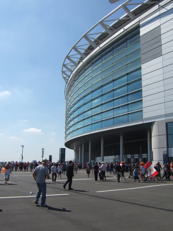 people walk near the entrance to an arena