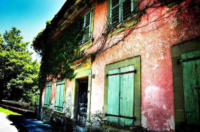 an old building with some windows and ivy growing on it