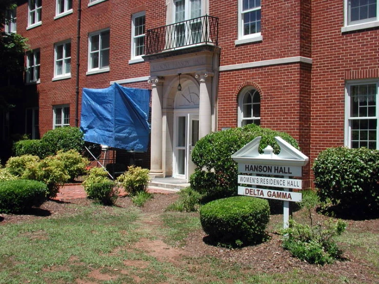 the front of a building with a large brick entrance