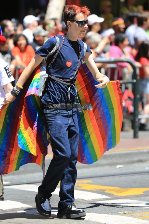 man with a large rainbow striped shawl on street