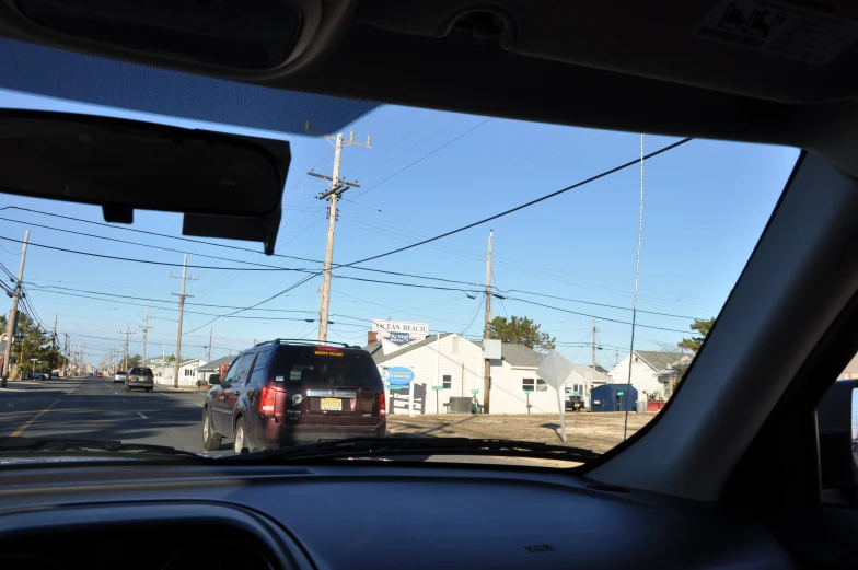 a car sits in the middle of an intersection as another passes